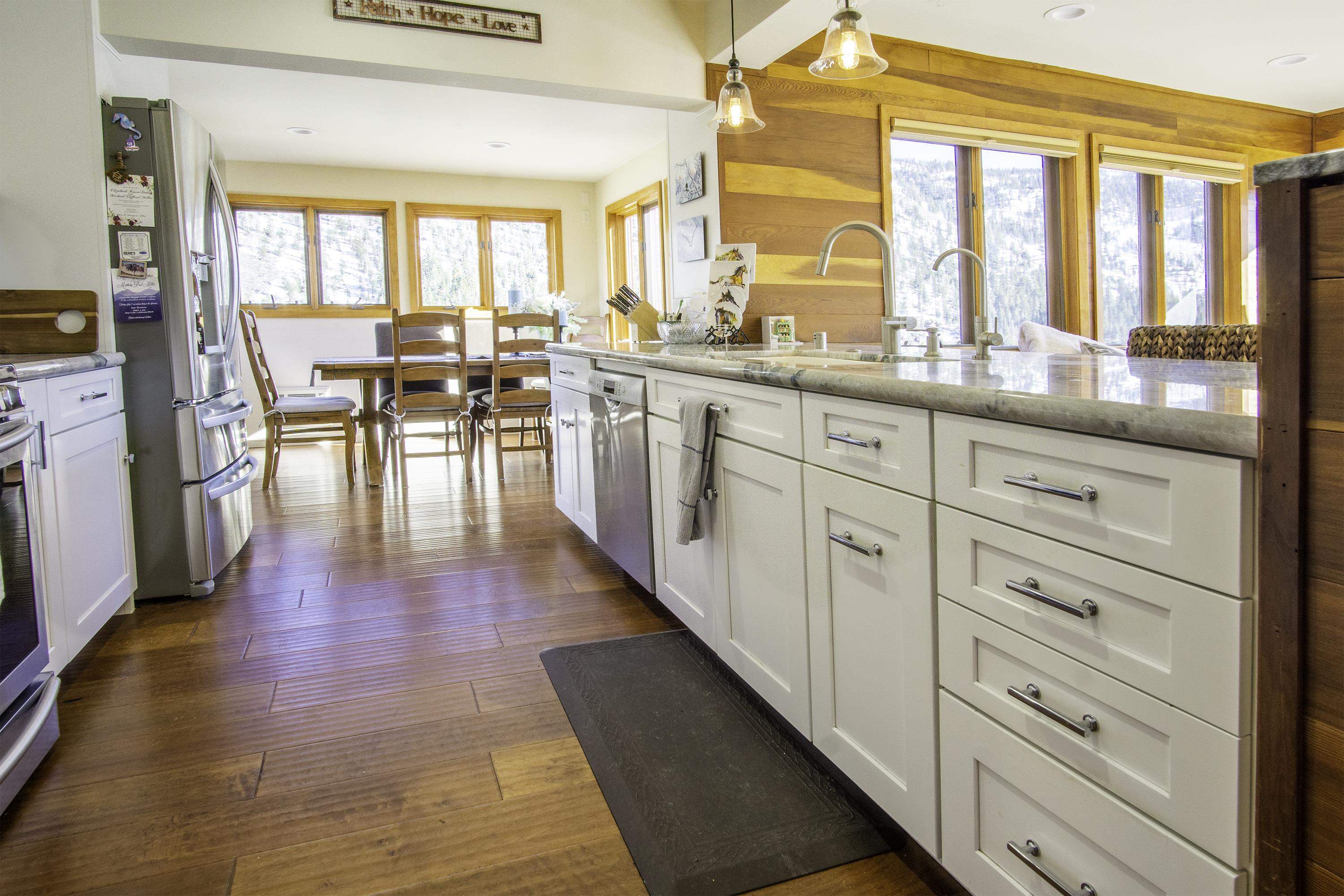 214 Skyline Road June Lake, CA 93529 - Photo 10 of 39 a hallway with white cabinets and wooden floor