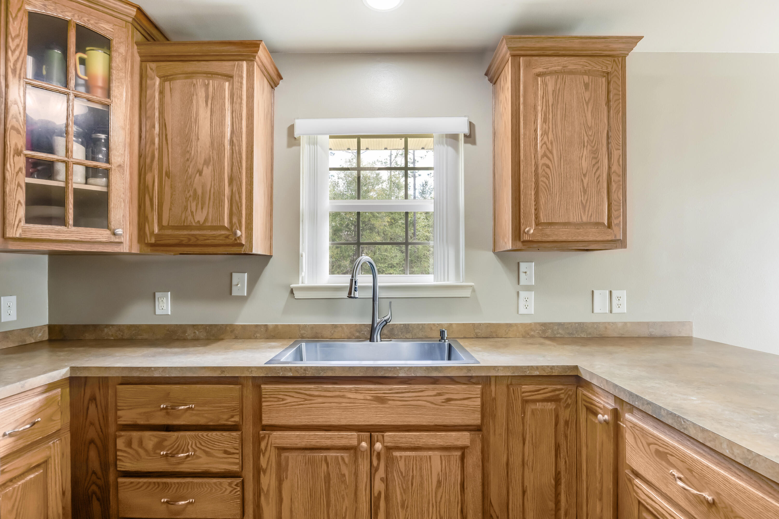 1582 Greenwood Road Baker, FL 32531 - Photo 12 of 49 a kitchen with stainless steel appliances granite countertop a sink a stove and cabinets