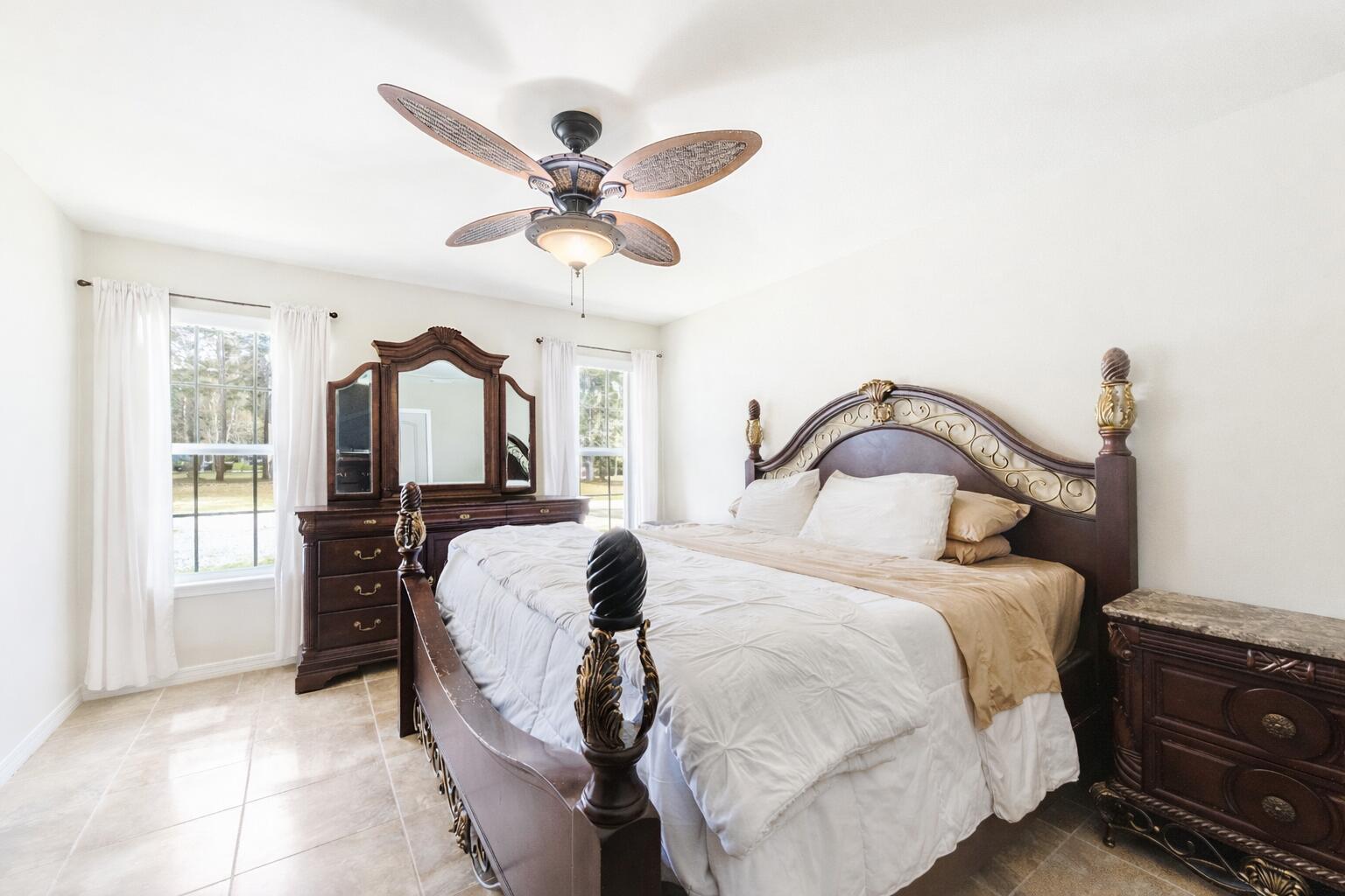 1582 Greenwood Road Baker, FL 32531 - Photo 16 of 49 a bedroom with a bed and dresser with mirror