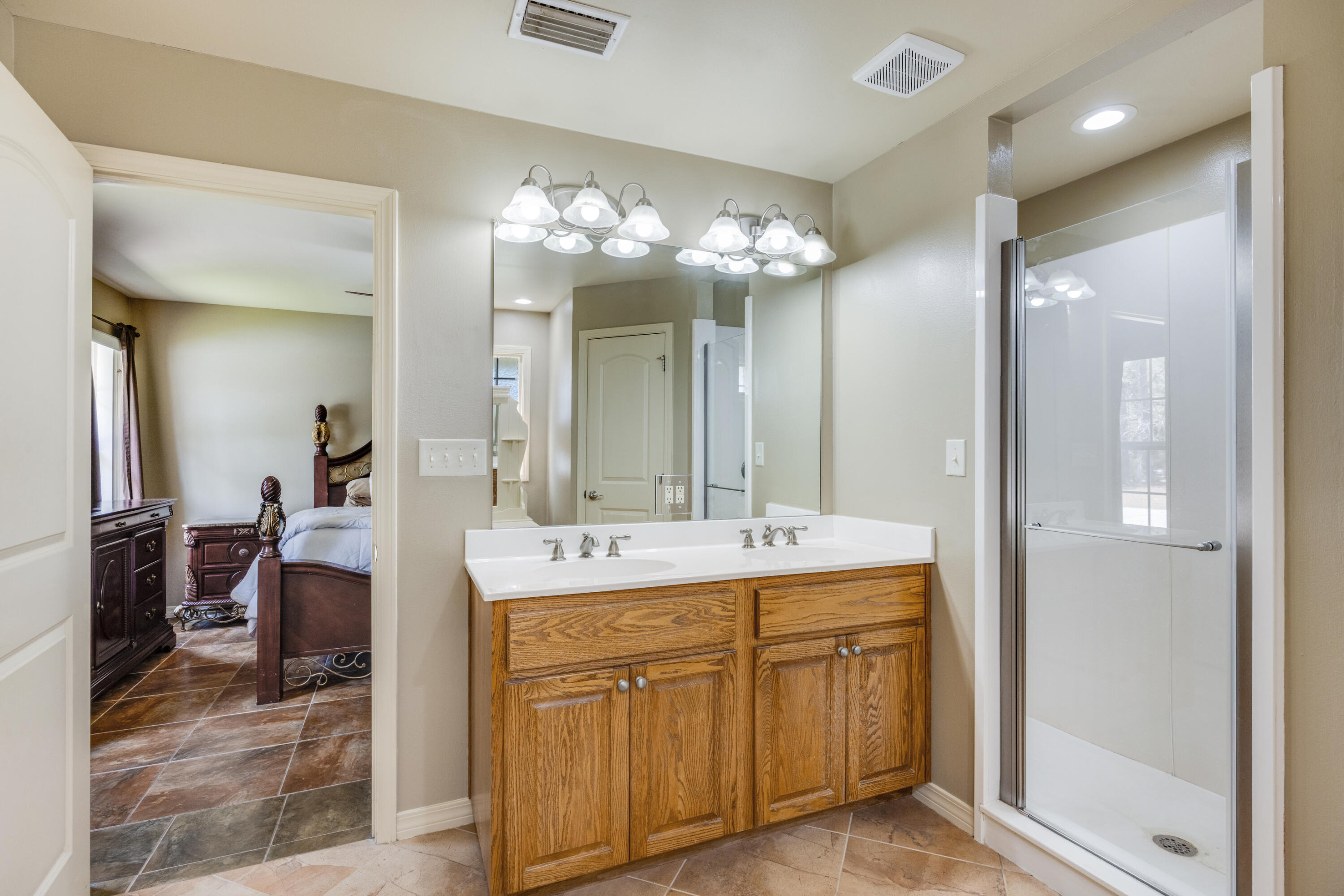 1582 Greenwood Road Baker, FL 32531 - Photo 18 of 49 a spacious bathroom with a double vanity sink and a mirror