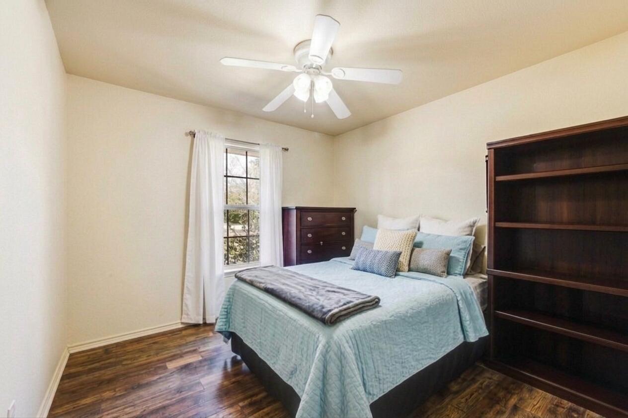 1582 Greenwood Road Baker, FL 32531 - Photo 24 of 49 a bedroom with a large bed and a chandelier fan