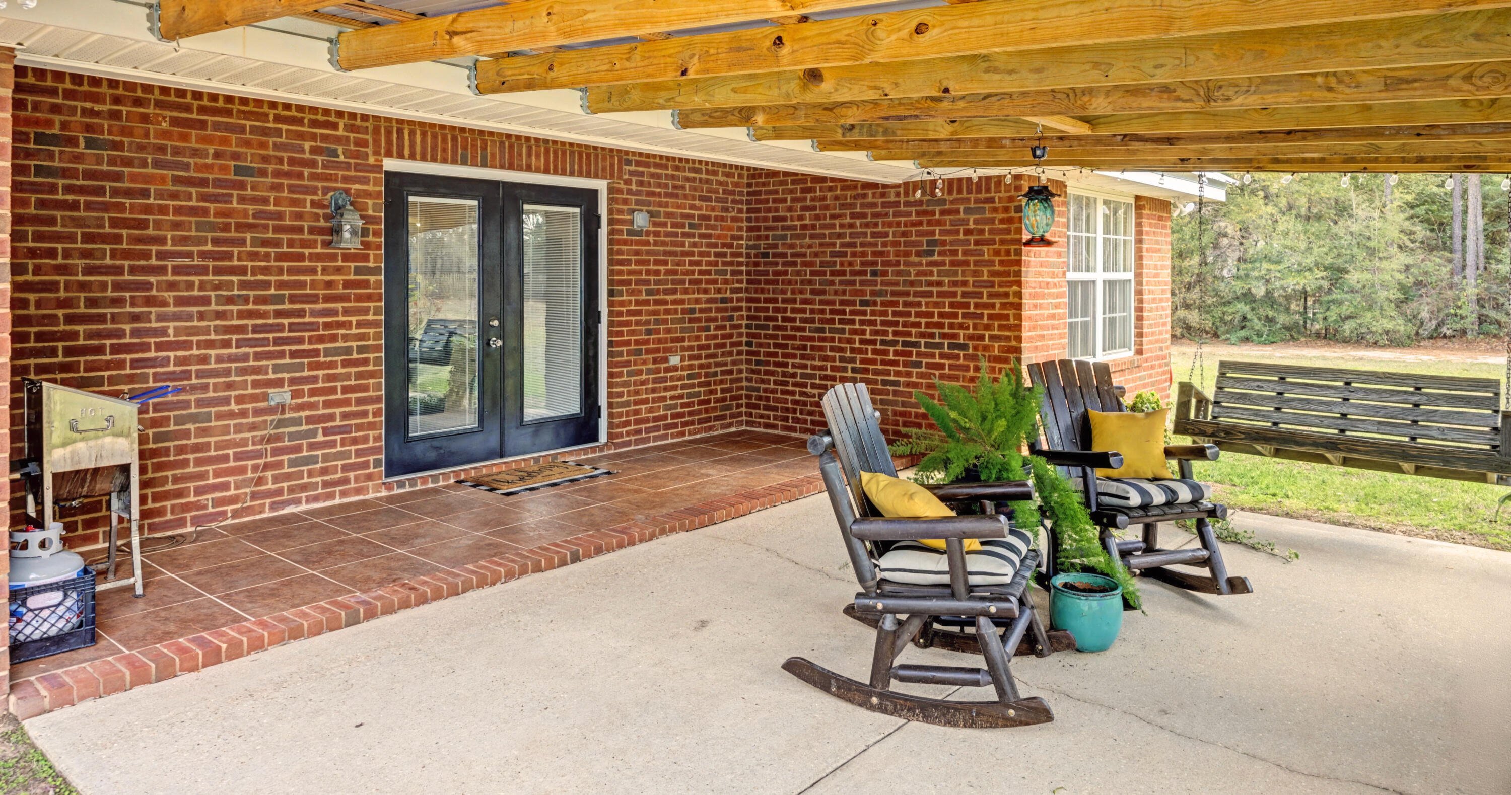 1582 Greenwood Road Baker, FL 32531 - Photo 29 of 49 a view of a patio with a table and chairs and potted plants