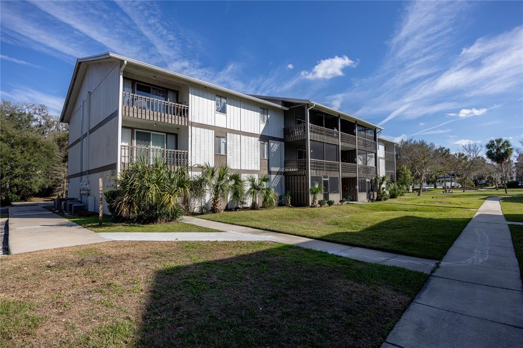 6519 West Newberry Road, Unit 1004 Gainesville, FL 32605 - Photo 15 of 17 a front view of a house with a yard
