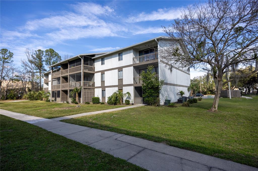 6519 West Newberry Road, Unit 1004 Gainesville, FL 32605 - Photo 2 of 17 a front view of a house with a yard