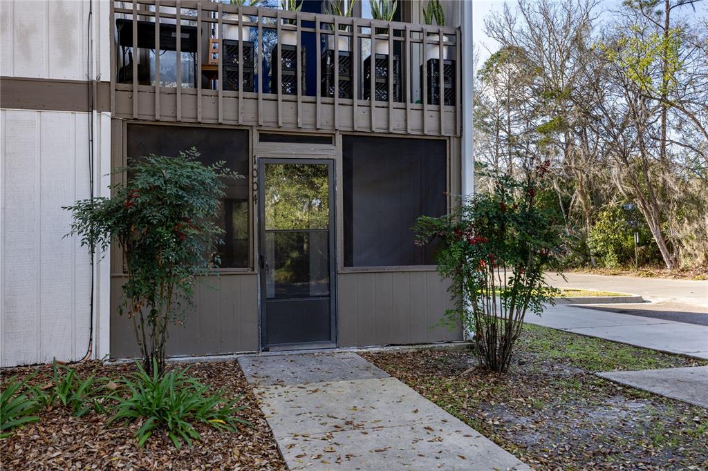 6519 West Newberry Road, Unit 1004 Gainesville, FL 32605 - Photo 3 of 17 a view of a house with a yard and potted plants
