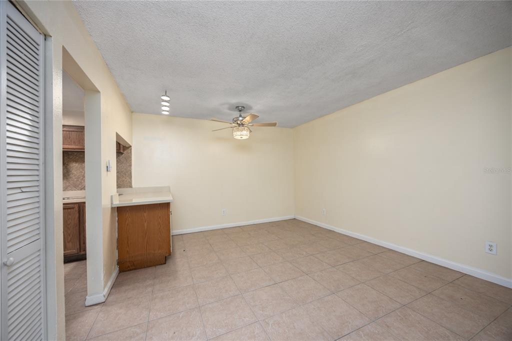 6519 West Newberry Road, Unit 1004 Gainesville, FL 32605 - Photo 5 of 17 an empty room with chandelier fan and windows