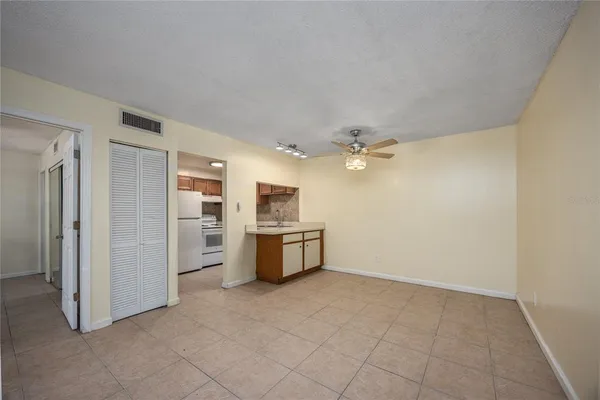 a view of a kitchen with refrigerator and microwave