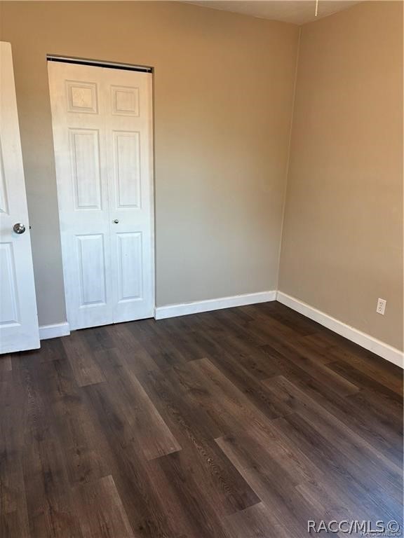 405 Copperfield Road Spring Hill, FL 34606 - Photo 13 of 25 a view of an empty room with wooden floor and closet