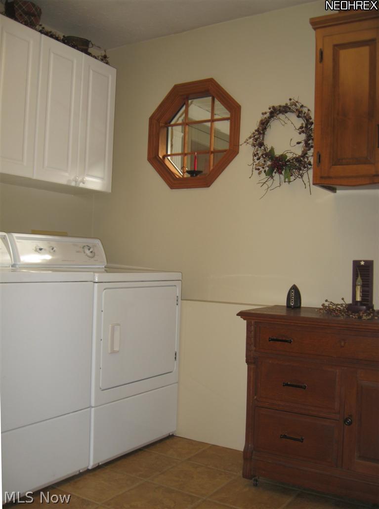 5313 Swepstone Street Northwest Canton, OH 44708 - Photo 21 of 25 First floor laundry has built in cabinets and a door to the garage