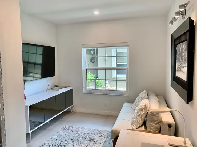 a living room with furniture window and a flat screen tv