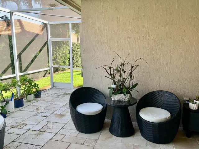 a view of a porch with furniture and a potted plant