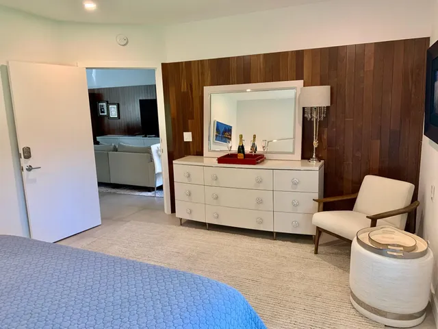 a living room with furniture and a mirror