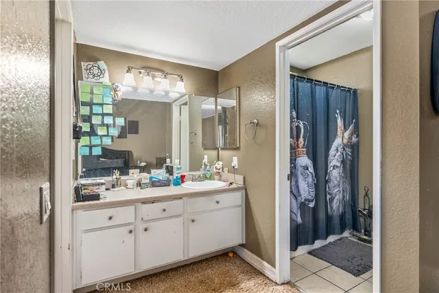 a bathroom with a double vanity sink mirror and shower