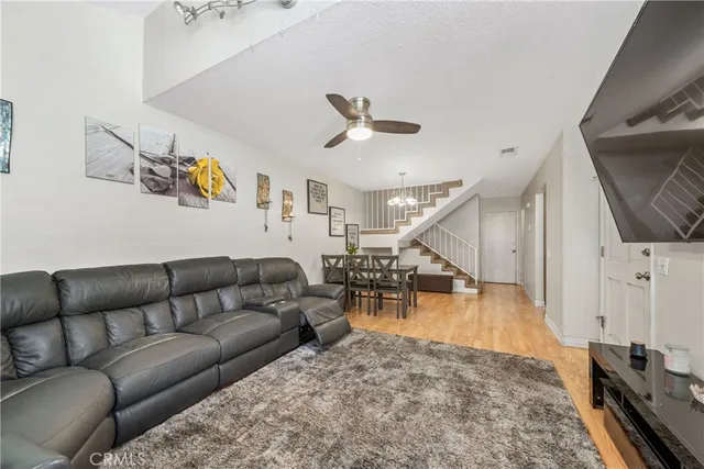 a living room with furniture and wooden floor