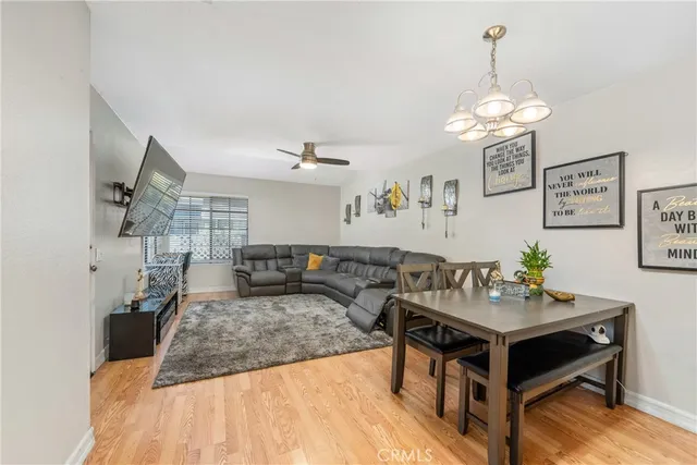 a living room with furniture a chandelier and a table