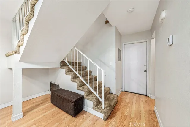 a view of entryway and hall with wooden floor