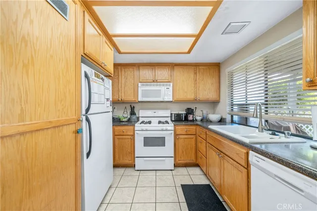 a kitchen with a sink cabinets stainless steel appliances and a window