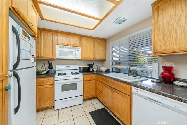 a kitchen with stainless steel appliances granite countertop a sink a stove and a refrigerator