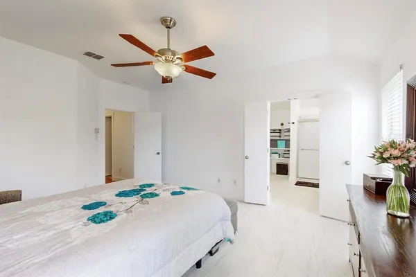 a bedroom with a bed dresser and a window