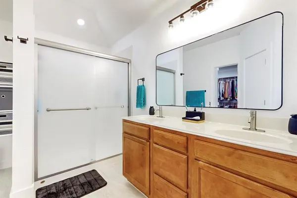 a bathroom with a double vanity sink and mirror