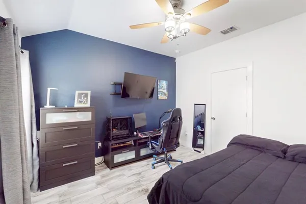 a bedroom with a bed and a chandelier