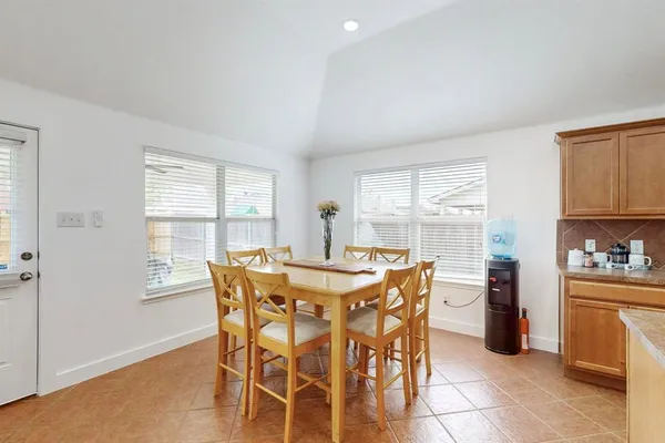 a view of a dining room with furniture and window