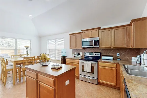 a kitchen with a stove a sink and a microwave