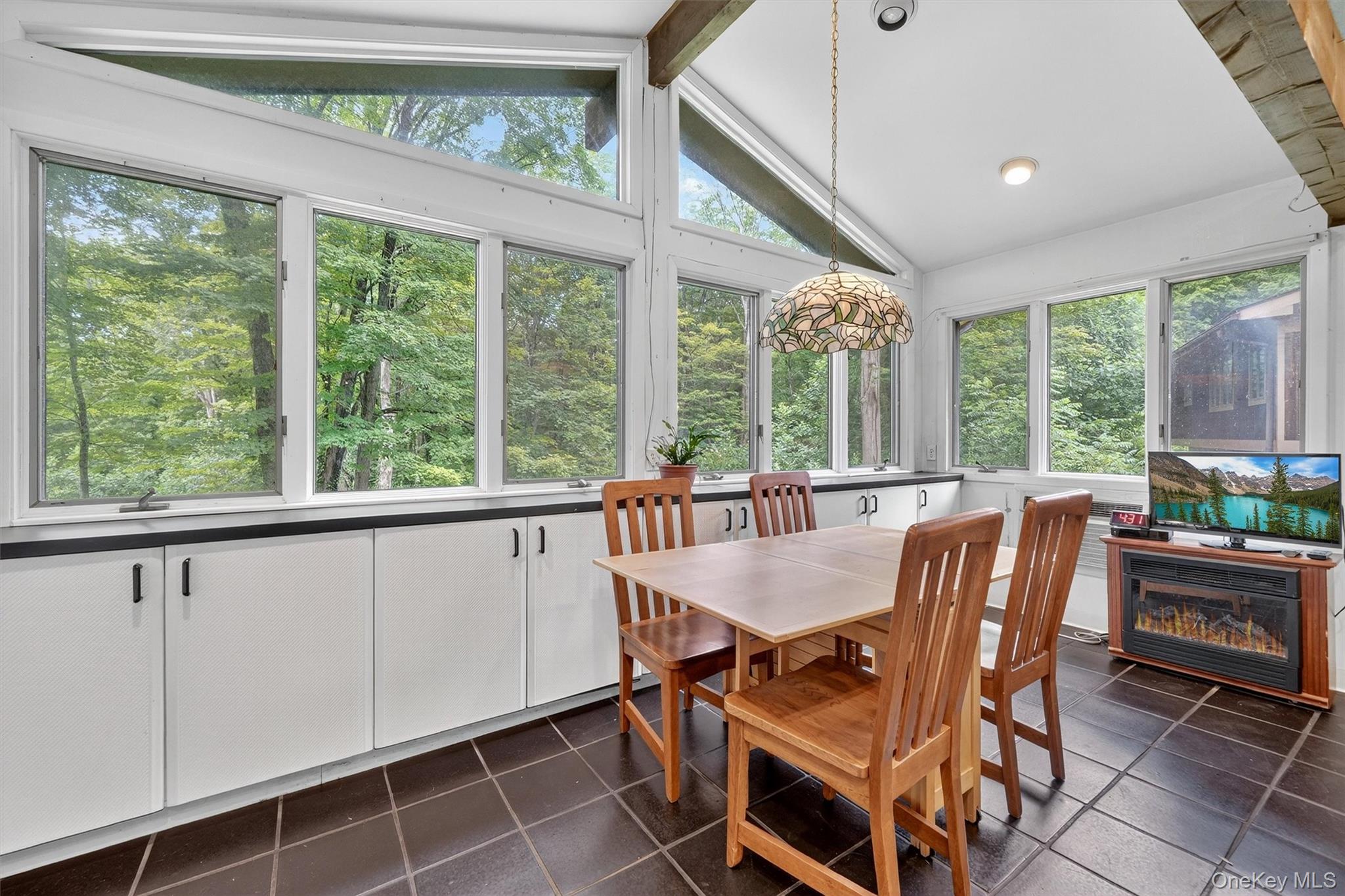 4 Cedar Hill Road Bedford, NY 10506 - Photo 17 of 50 a view of a dining room with furniture large windows and wooden floor