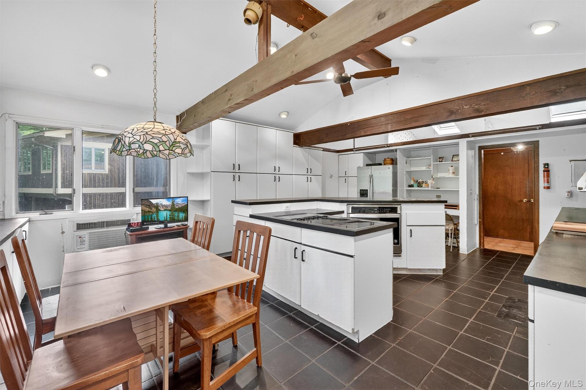 4 Cedar Hill Road Bedford, NY 10506 - Photo 18 of 50 a kitchen with stainless steel appliances a stove a table and chairs