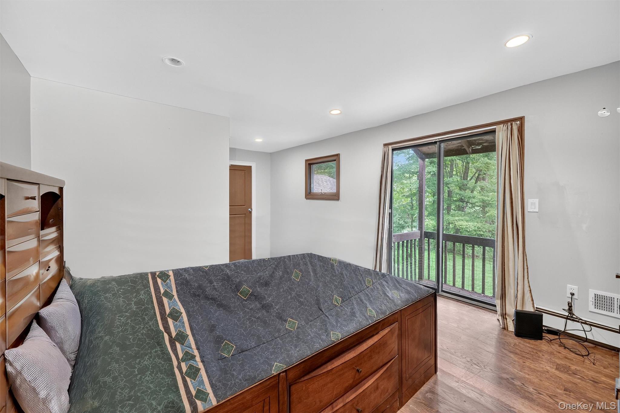 4 Cedar Hill Road Bedford, NY 10506 - Photo 21 of 50 a living room with a bed furniture and a large window