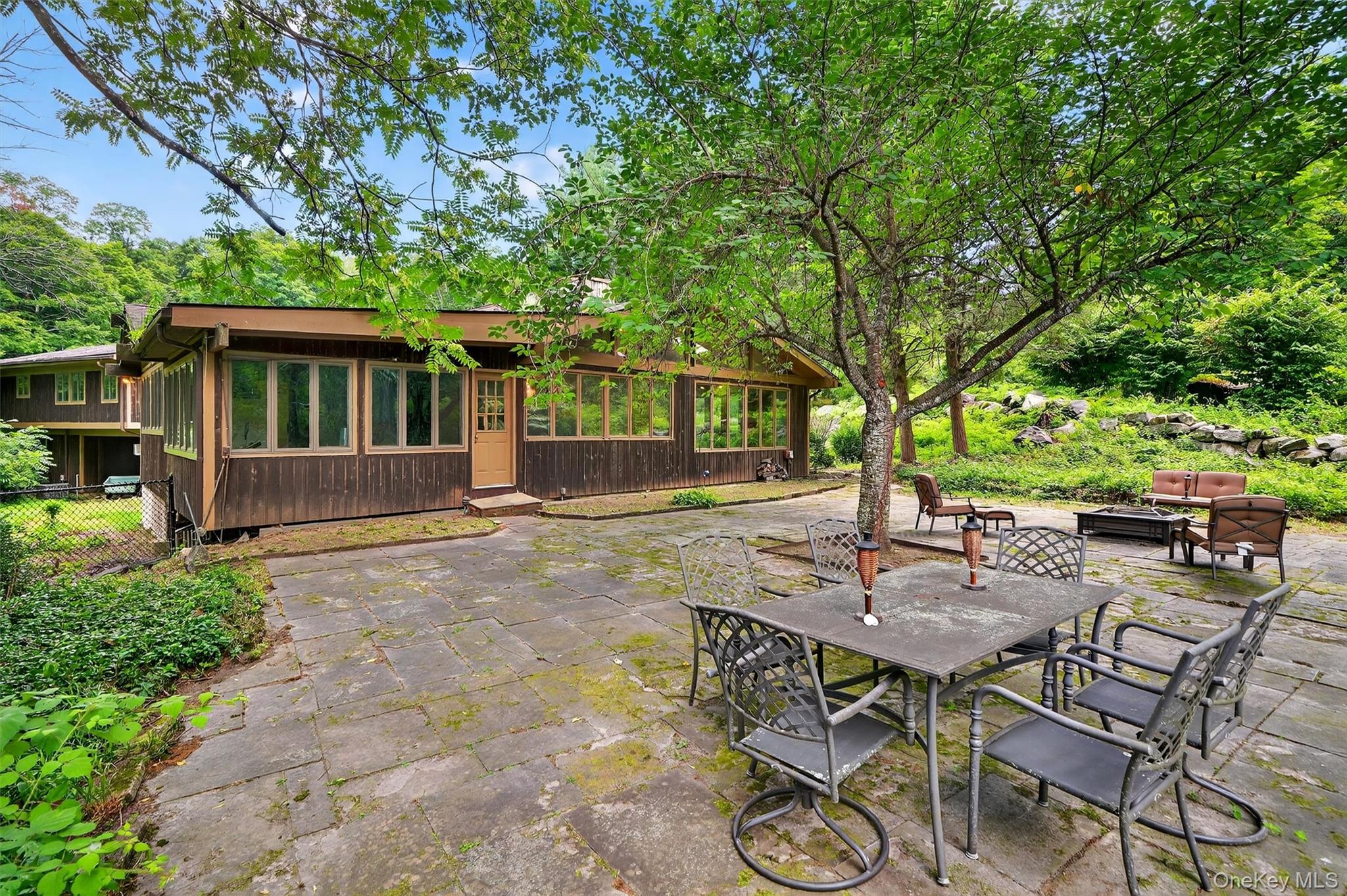 4 Cedar Hill Road Bedford, NY 10506 - Photo 42 of 50 a view of backyard with table and chairs and potted plants