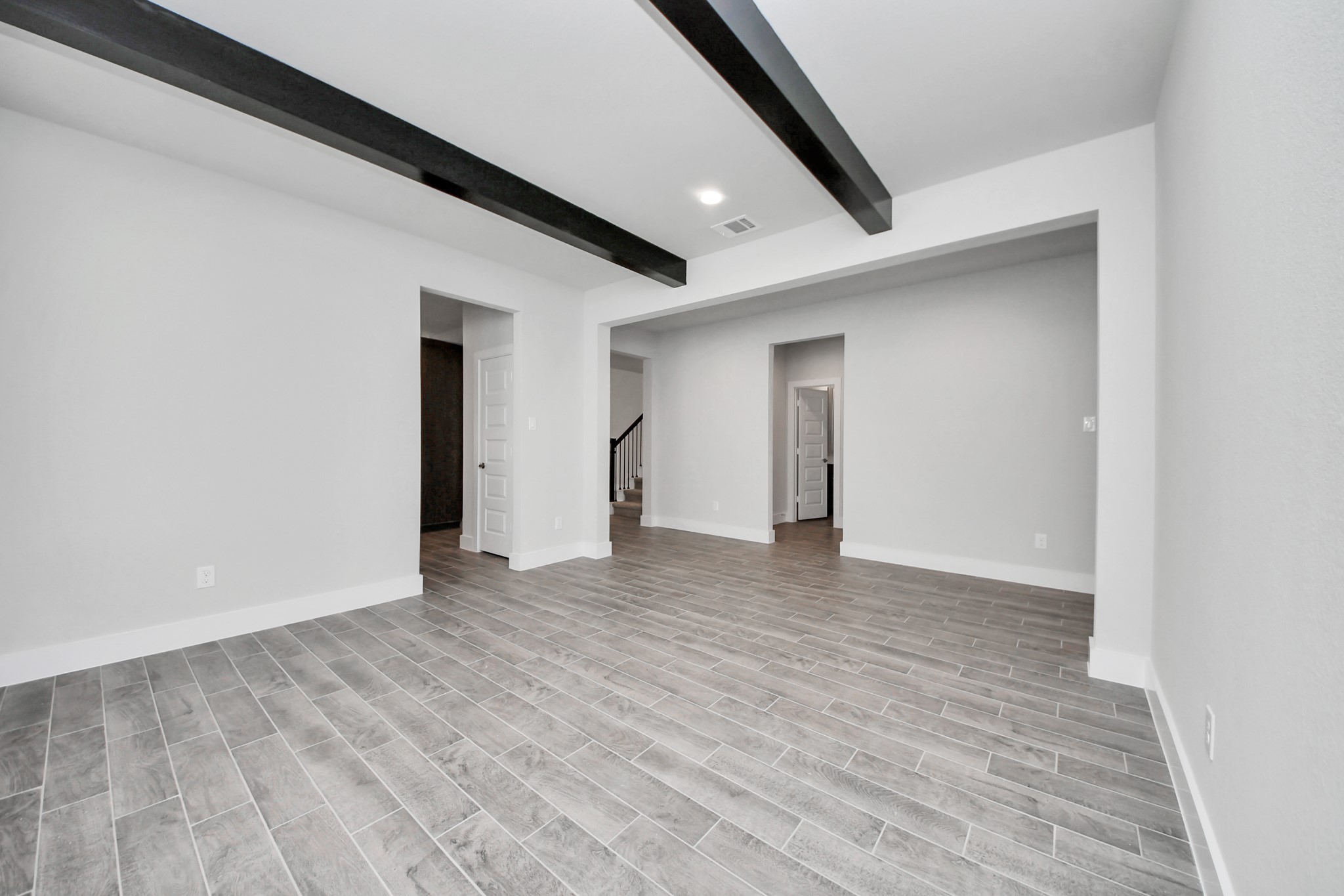 3023 Native Spg Drive Spring, TX 77373 - Photo 10 of 50 Create lasting memories with your family and friends at the dining table! This expansive dining room showcases sophisticated flooring, custom paint, and seamlessly connects to the family room and kitchen, providing an open and inviting atmosphere.