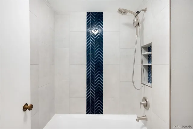 a bathroom with a bathtub and a shower