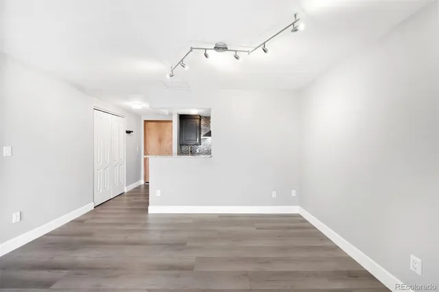 a view of a room with wooden floor