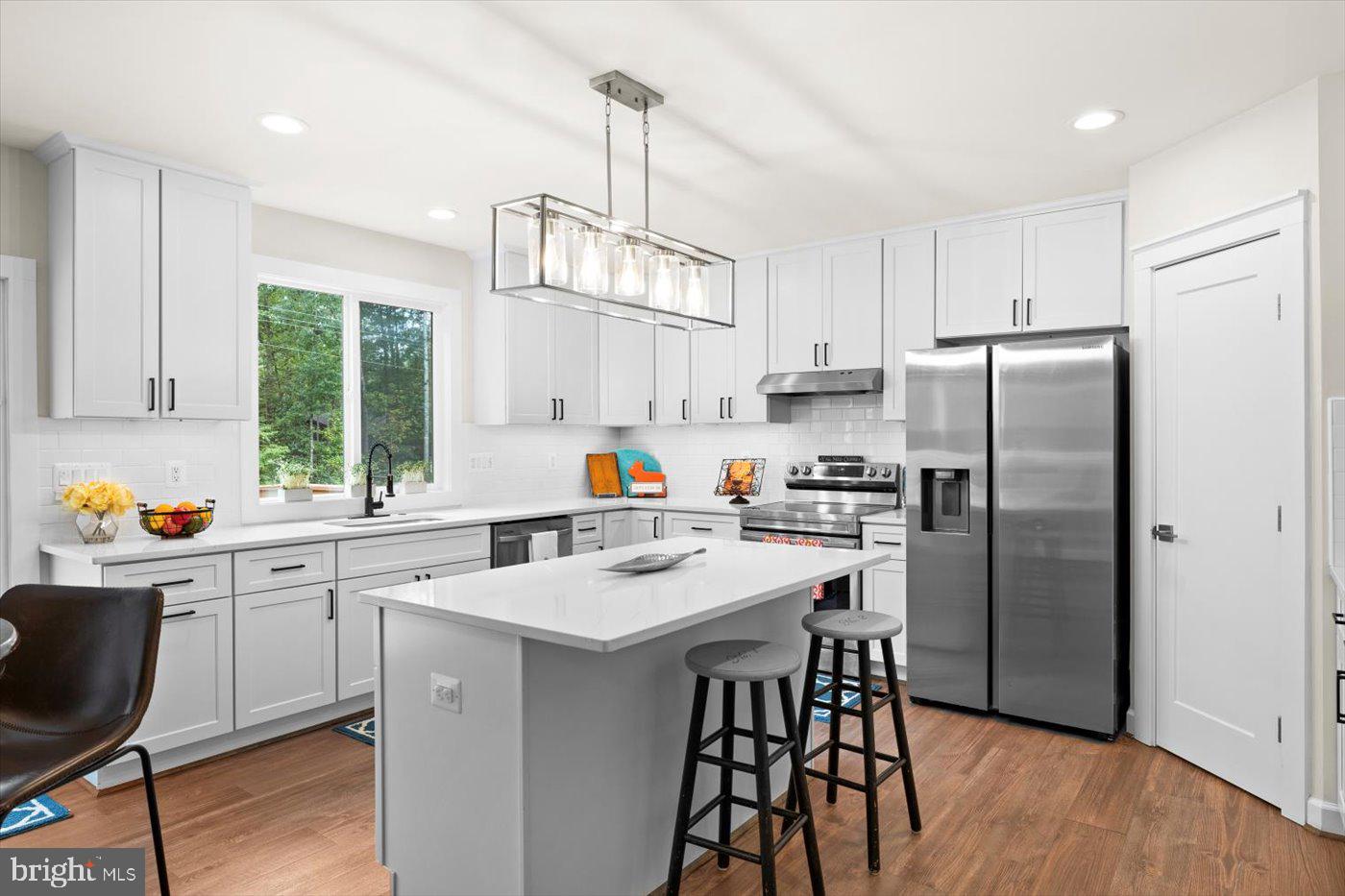 537 Monticello Circle Locust Grove, VA 22508 - Photo 17 of 107 a kitchen with stainless steel appliances a refrigerator a sink a stove a dining table and chairs
