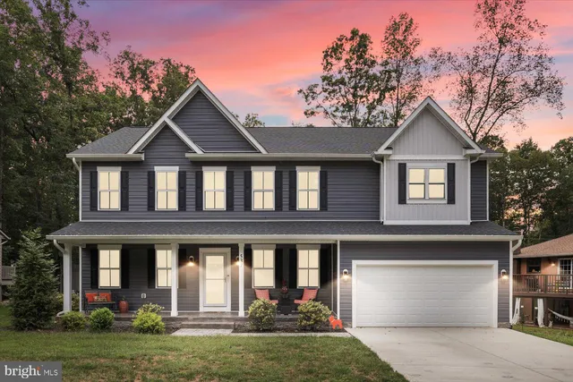 front view of a house with a chairs and table in a patio