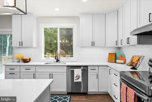 a living room with furniture a rug a lamp and a window