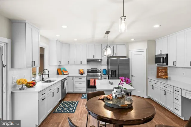 a spacious bedroom with a bed and wooden floor