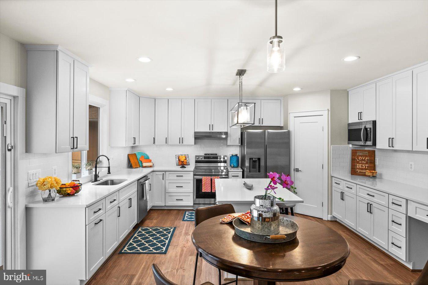 537 Monticello Circle Locust Grove, VA 22508 - Photo 25 of 107 a kitchen with stainless steel appliances kitchen island granite countertop a dining table and chairs