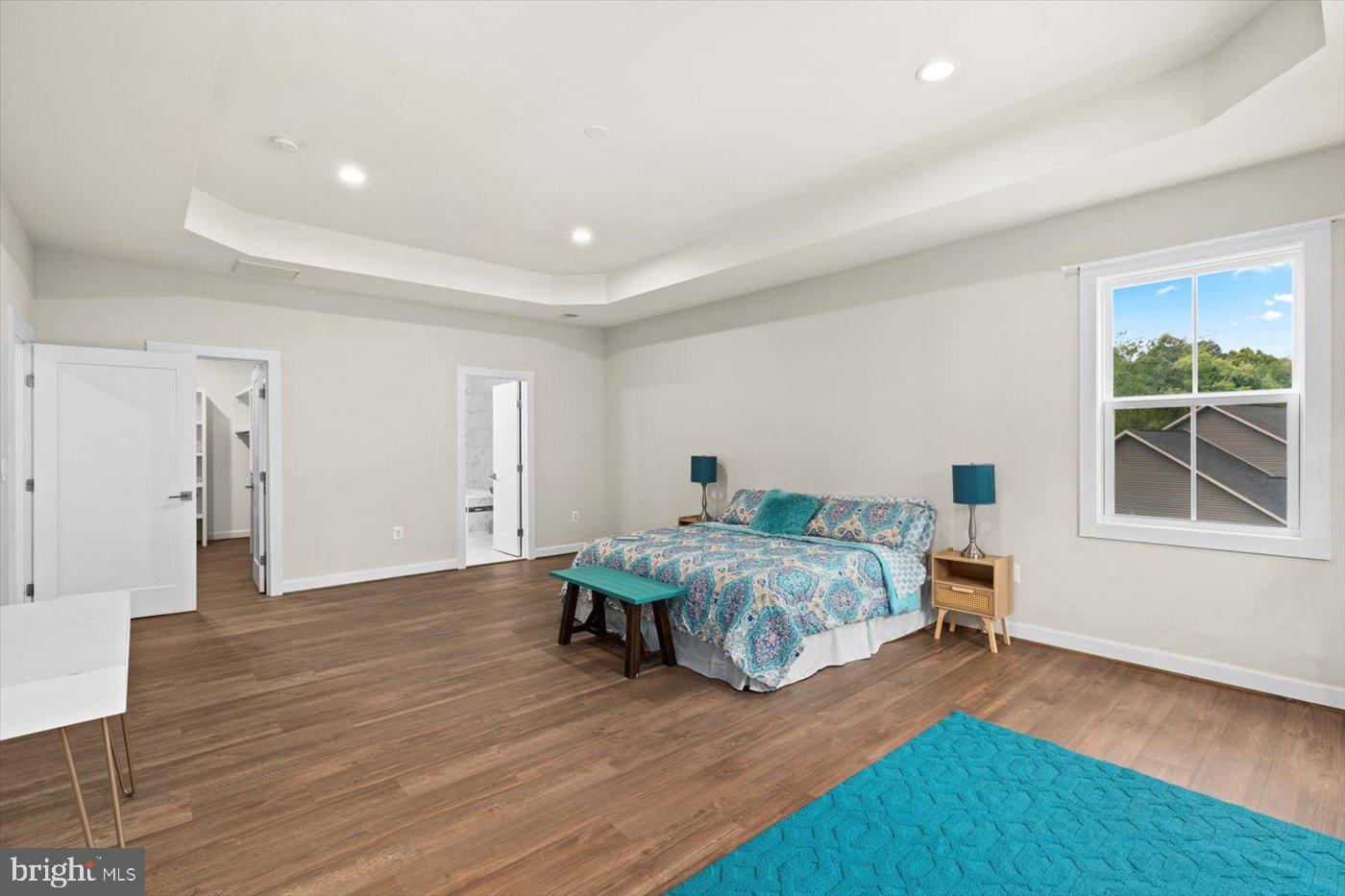 537 Monticello Circle Locust Grove, VA 22508 - Photo 44 of 107 a spacious bedroom with a bed and wooden floor