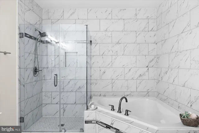 an aerial view of a residential houses with outdoor space and trees all around