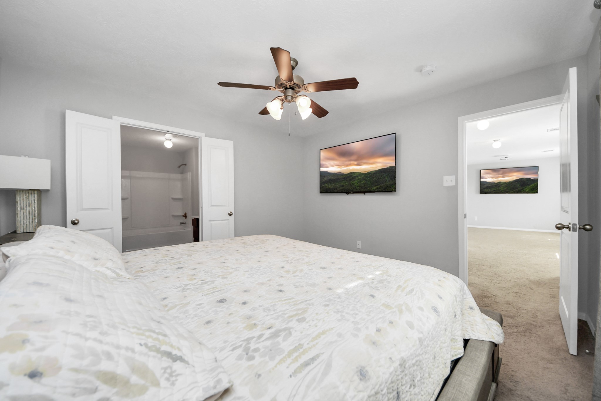 696 Road 5105 Cleveland, TX 77327 - Photo 12 of 25 a bedroom with a bed and a flat screen tv