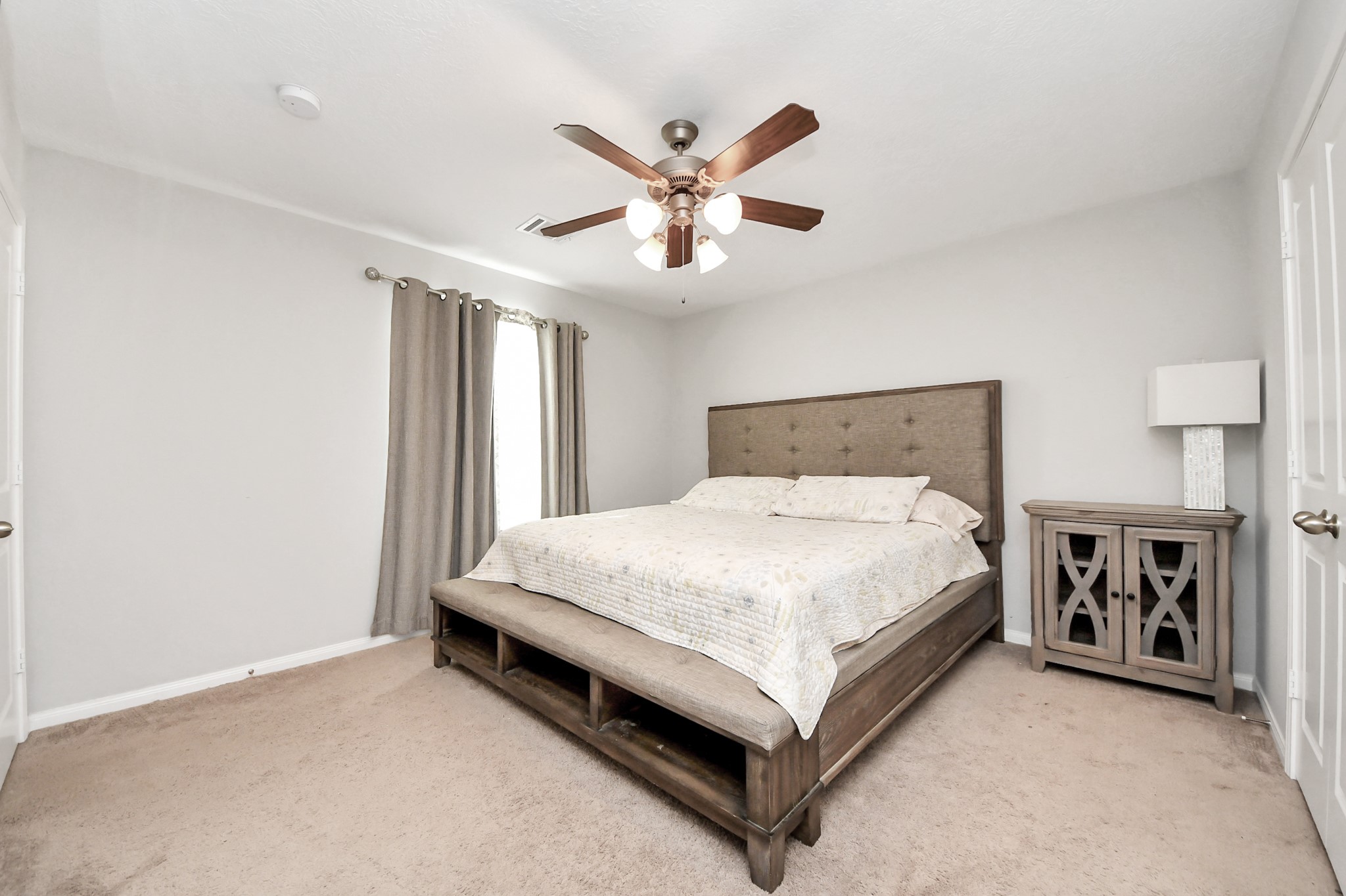 696 Road 5105 Cleveland, TX 77327 - Photo 13 of 25 a bed room with a bed and a ceiling fan
