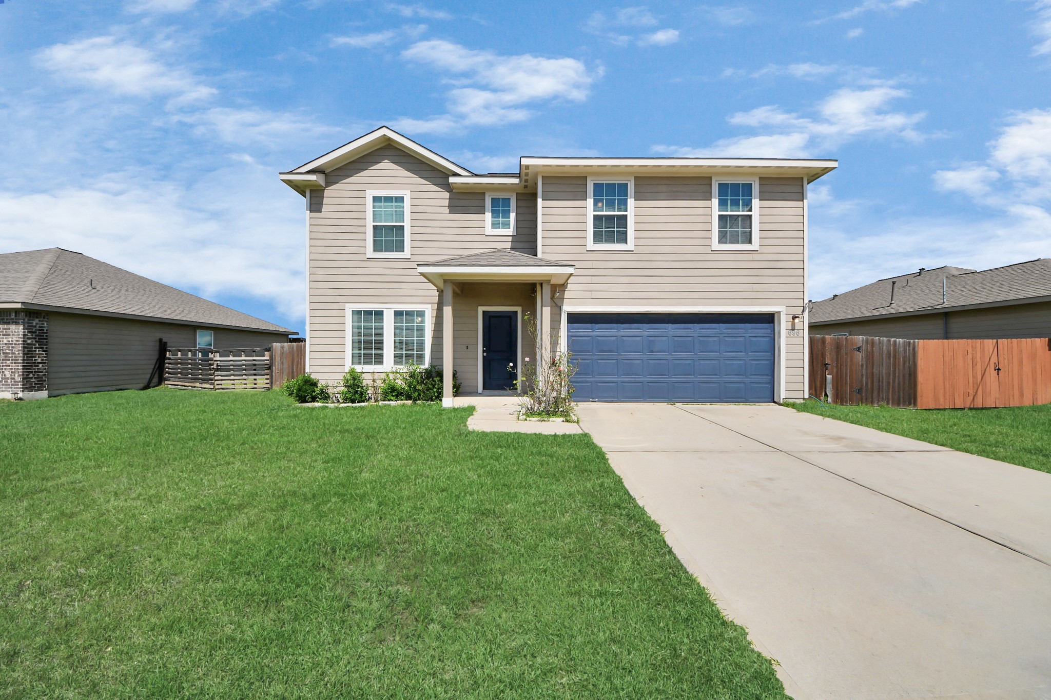 696 Road 5105 Cleveland, TX 77327 - Photo 2 of 25 a front view of a house with a yard and garage