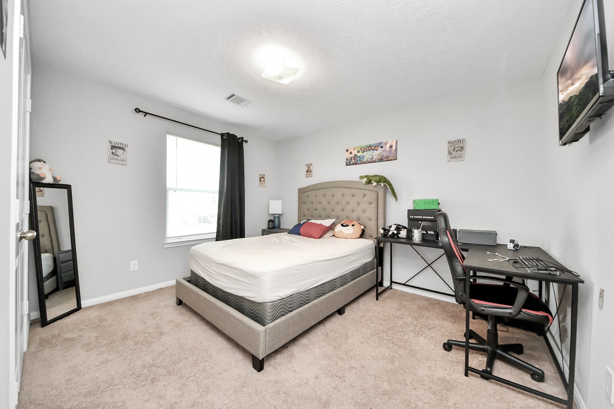 696 Road 5105 Cleveland, TX 77327 - Photo 22 of 25 a bedroom with a bed a desk and chair