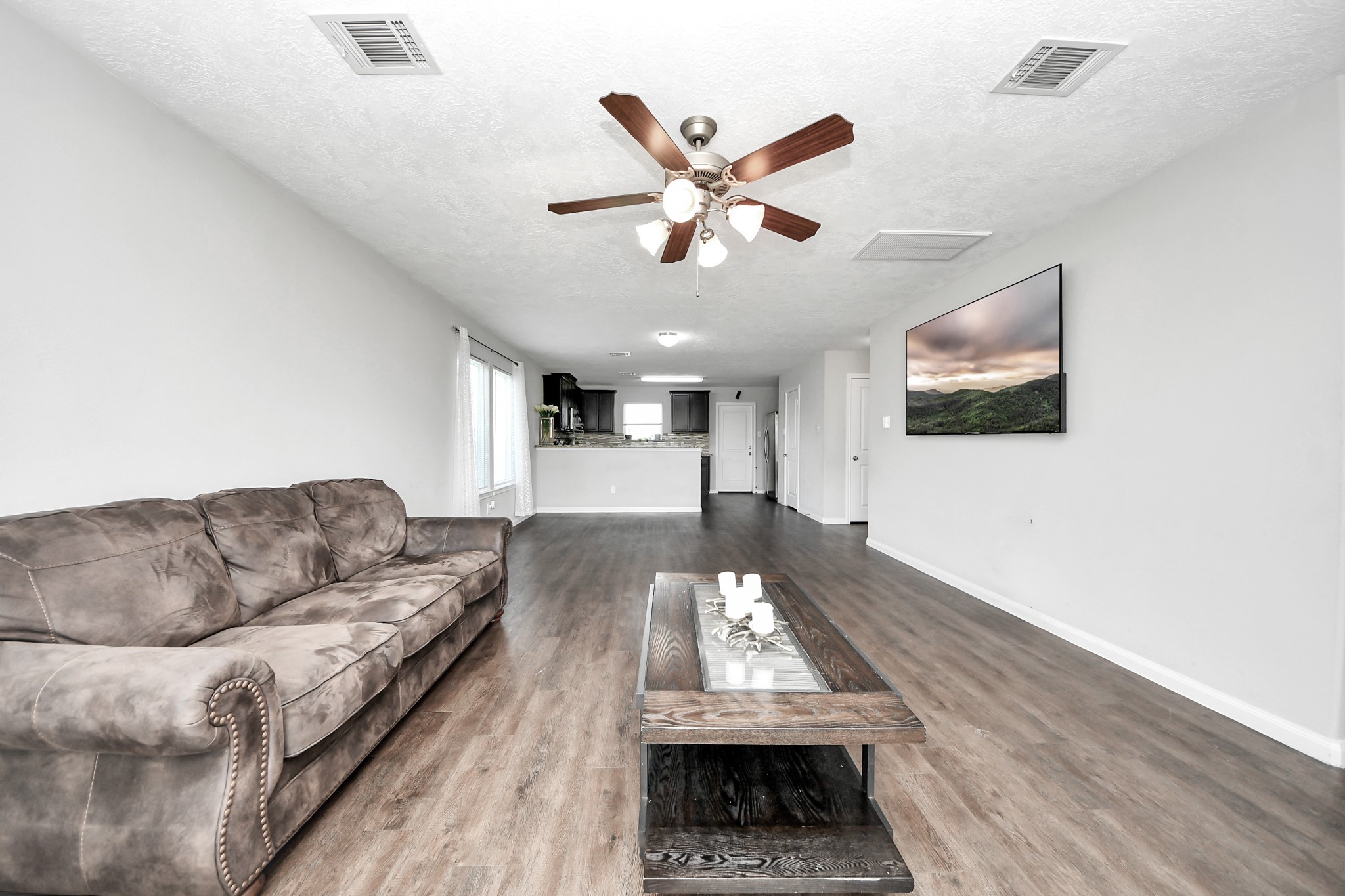 696 Road 5105 Cleveland, TX 77327 - Photo 8 of 25 a living room with furniture and a flat screen tv