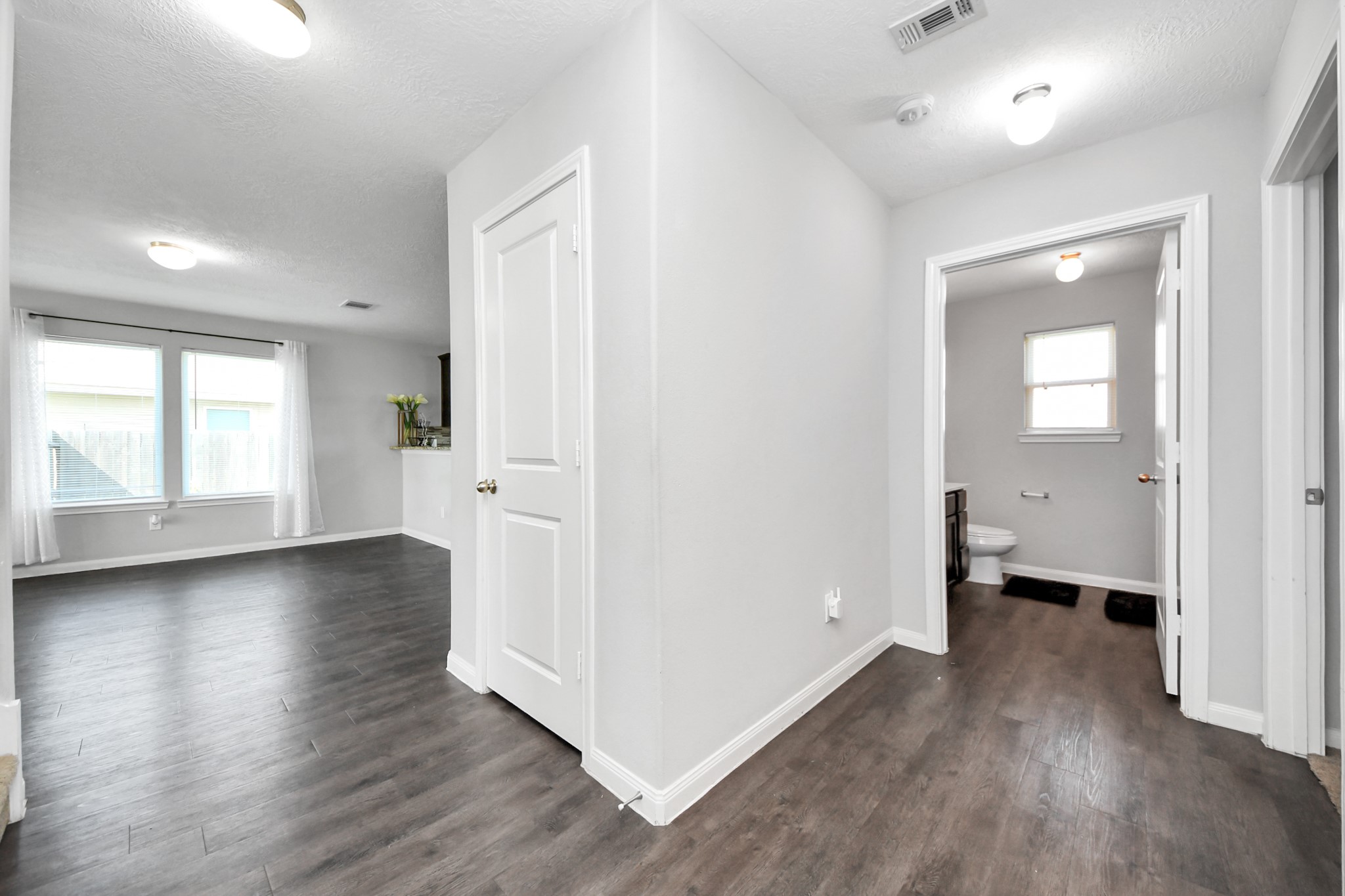 696 Road 5105 Cleveland, TX 77327 - Photo 9 of 25 an empty room with wooden floor and windows