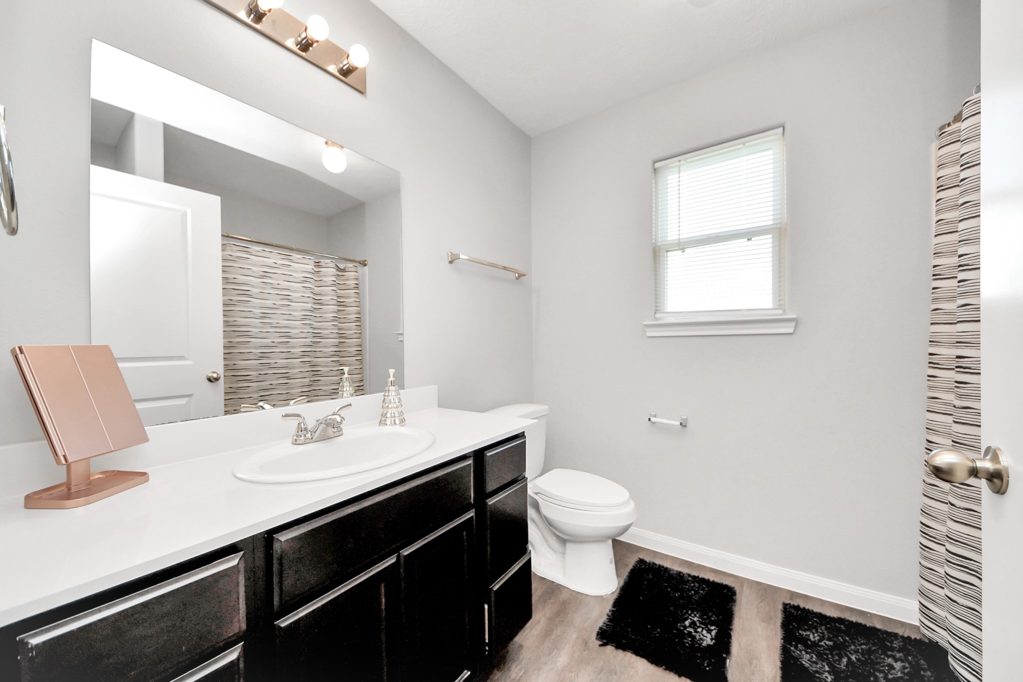 696 Road 5105 Cleveland, TX 77327 - Photo 10 of 25 a bathroom with a sink and a mirror