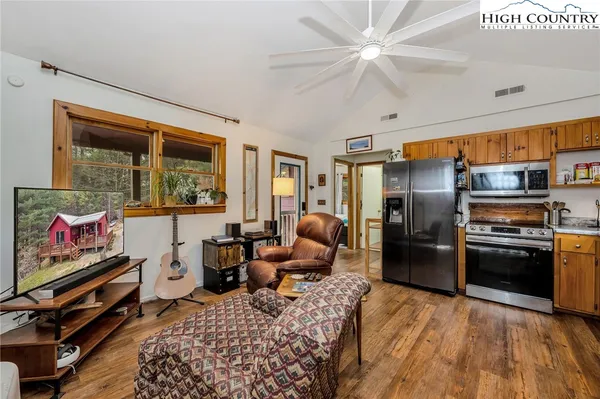 a kitchen with stainless steel appliances granite countertop a refrigerator a stove top oven a sink and dishwasher