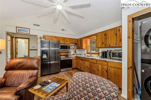 a very nice looking living room with a large window wooden floor and furniture